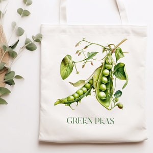 May include: A white tote bag featuring an illustration of a green pea pod and the text "GREEN PEAS" printed on the front.