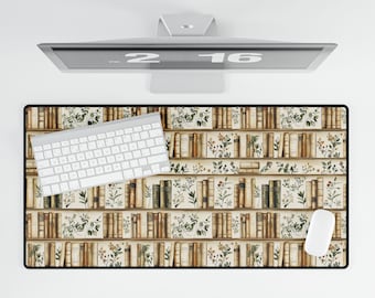 May include: A rectangular desk mat featuring a bookshelf design with rows of vintage books and floral accents. A white keyboard and mouse are positioned on the mat, with a computer monitor above.