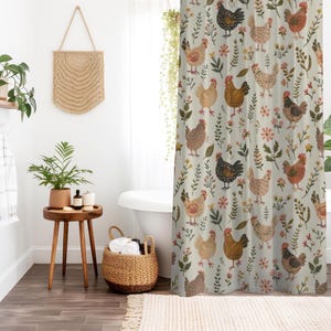 May include: A shower curtain featuring a repeating pattern of chickens in shades of brown, black, and white, interspersed with small green leaves and pink and yellow flowers on a light cream background, creating a farm-inspired textile design.