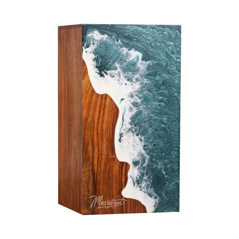 May include: A rectangular wooden box with a teal and white resin wave design. The resin is poured into the wood and has a textured, foamy look. The box is signed "Maxwood" in the lower right corner.