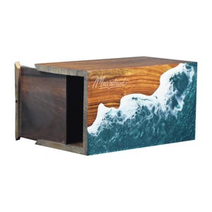 May include: A wooden box with a drawer, featuring a teal and white resin wave design on the front. The box is made by Maxwood.