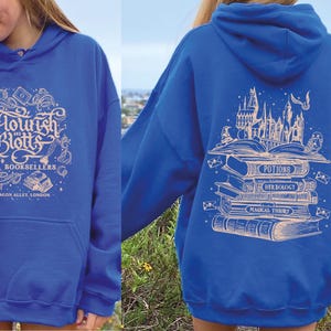 May include: A royal blue hoodie with a white graphic of a stack of books and the text "Flourish and Blotts Booksellers Diagon Alley, London".