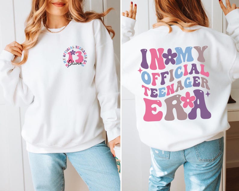 May include: White sweatshirt with a pink, blue, and purple graphic that says "In My Official Teenager Era" with flowers. The front of the sweatshirt has a smaller graphic with the number 13 and the name Olivia.