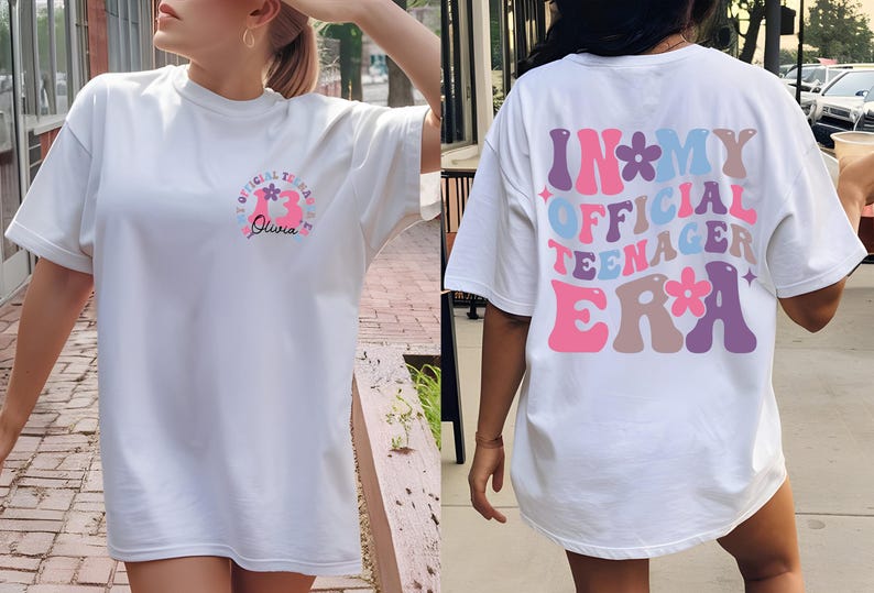 May include: White t-shirt with a pink and blue graphic that says "Official Teenager Era" with flowers on the back. The front of the shirt has a pink and blue graphic that says "Official Teenager Era" with flowers and the name "Olivia" underneath.