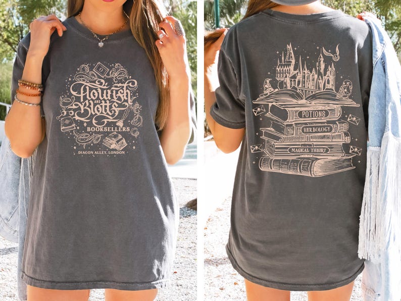May include: A gray t-shirt with a vintage-style graphic of a bookstore called "Flourish and Blotts" with the text "Booksellers, Diagon Alley, London". The back of the shirt features a graphic of a stack of books with the titles "Potions", "Herbology", and "Magical Theory" and a castle in the background.