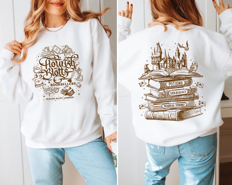 May include: White sweatshirt with a brown graphic print of the text "Flourish and Blotts Booksellers Diagon Alley London" on the front and a brown graphic print of a stack of books with the text "Potions, Herbology, Magical Theory" on the back.