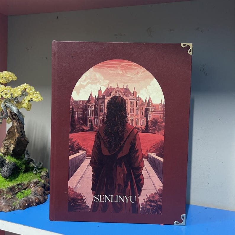 May include: A hardcover book with a burgundy cover featuring an illustration of a person in a red coat facing a large building. The book has gold corner protectors and the word "SENLINYU" is printed at the bottom.