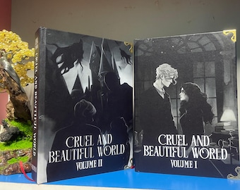 Cruel and World Book Set - 2 volúmenes de tapa dura con detalles metálicos