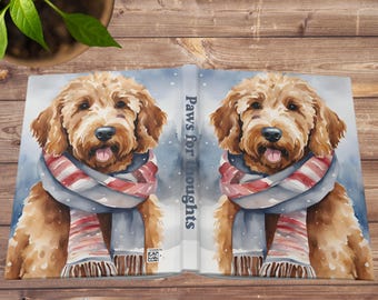 May include: A watercolor illustration of a brown and white dog wearing a blue and red striped scarf. The dog is looking at the camera with its tongue sticking out. The text "Paws for thoughts" is printed on the spine of the book.