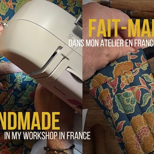May include: A close-up of a sewing machine stitching a colorful fabric with a floral pattern. The text "HANDMADE IN MY WORKSHOP IN FRANCE" is visible below the fabric. The image is split in half, with the right side showing a hand holding a wooden object wrapped in the same fabric. The text "FAIT-MAIN DANS MON ATELIER EN FRANCE" is visible above the object.