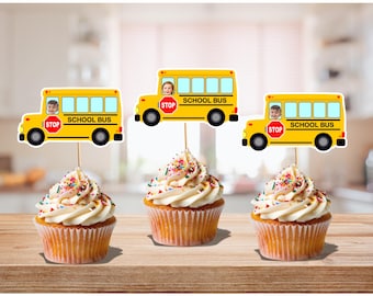 Peut inclure: Trois cupcakes avec glaçage blanc et des vermicelles colorés. Chaque cupcake est surmonté d'un décor de bus scolaire jaune avec l'inscription "SCHOOL BUS" et une image d'enfant. Les décorations de bus scolaire ont un panneau "STOP" rouge.