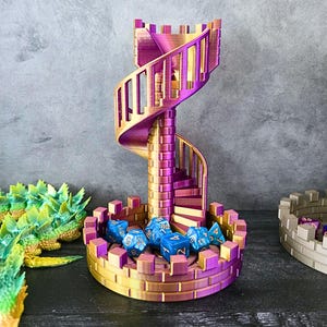 May include: A gold and purple 3D printed tower with a spiral staircase. The tower has a base with a moat and a small dragon statue. There are blue dice in the moat.