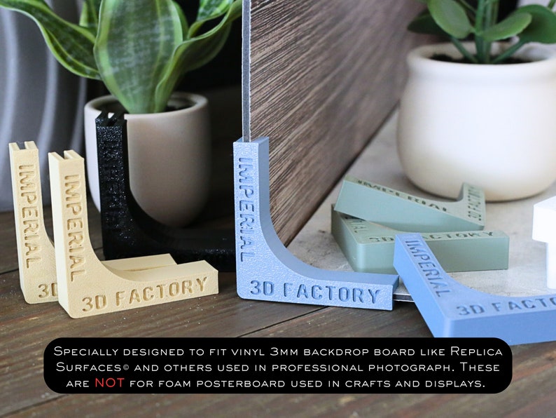 May include: A set of four corner supports for backdrops, made of plastic and printed with the words "Imperial 3D Factory". The supports are in various colors, including blue, green, black, and beige.