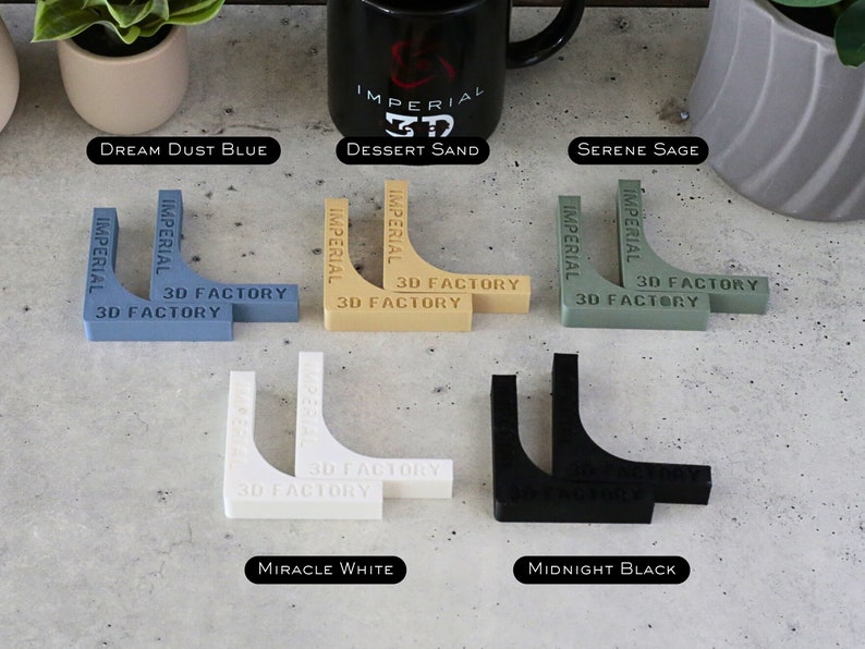 May include: Two sets of corner brackets in six different colors: dream dust blue, dessert sand, serene sage, miracle white, and midnight black. Each set has two brackets with the text "Imperial 3D Factory" printed on them.