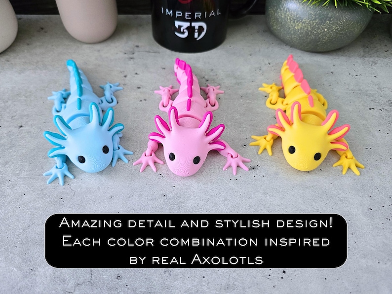 May include: Three articulated axolotl figurines in light blue, pink, and yellow with contrasting dorsal fins and black eyes. The text reads: AMAZING DETAIL AND STYLISH DESIGN! EACH COLOR COMBINATION INSPIRED BY REAL AXOLOTLS.