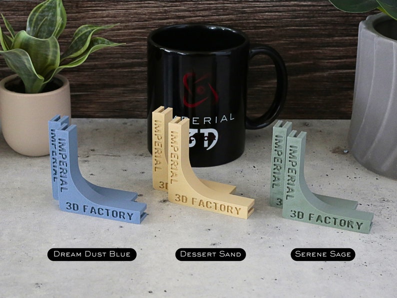 May include: Three 3D printed corner brackets in different colors: Dream Dust Blue, Dessert Sand, and Serene Sage. Each bracket has the text "IMPERIAL 3D FACTORY" printed on it.