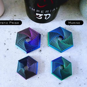 May include: Four hexagonal metal coasters with a swirling, layered design. The coasters are in shades of blue, green, and purple. The coasters are labeled "Mystic Prism" and "Marine".