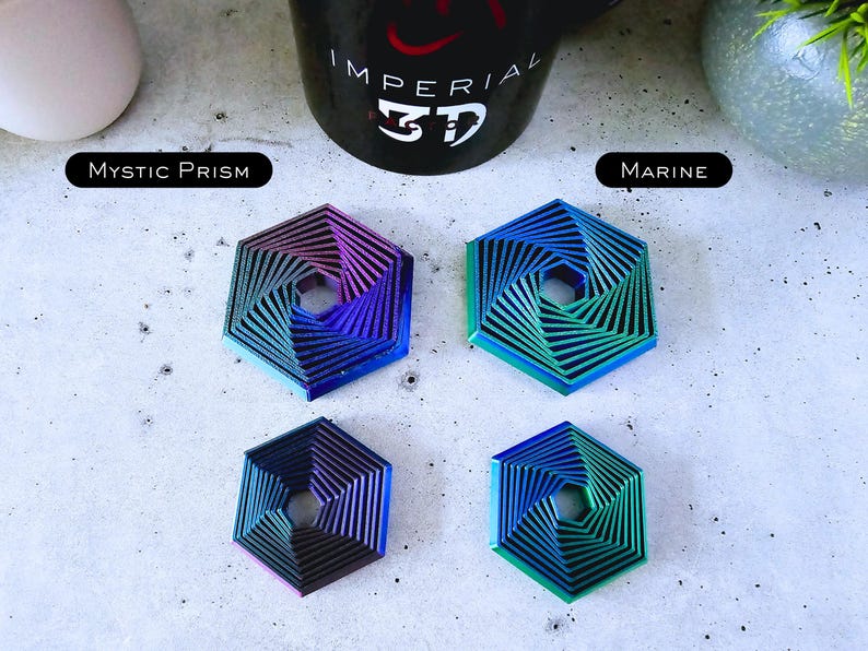 May include: Four hexagonal metal coasters with a swirling, layered design. The coasters are in shades of blue, green, and purple. The coasters are labeled "Mystic Prism" and "Marine".