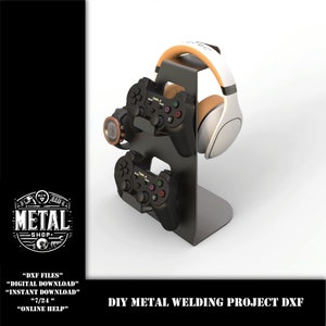 May include: A black metal stand with two black video game controllers and a white and brown headset. The stand is designed to hold the controllers and headset upright. The stand is a DIY metal welding project.