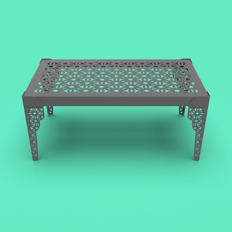 May include: A gray metal table with a geometric pattern cut out of the top. The table has a rectangular top and four legs.