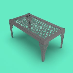 May include: A gray metal table with a geometric pattern cut out of the top and decorative legs. The table is on a turquoise background.