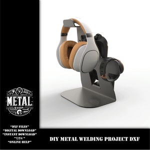 May include: A metal stand for headphones and a controller. The stand is black with a silver base. The headphones are white with brown earcups. The controller is black with a brown strap. The stand is a DIY metal welding project.