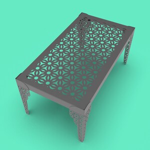 May include: A gray metal table with a geometric pattern cut out of the top. The table has four legs with a similar geometric pattern.