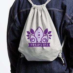 May include: A gray drawstring bag with a purple yoga-inspired design and the text "YOGA LIFE" printed on the front.