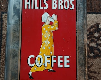 May include: A white ceramic mug with a black handle and the text "But First, Coffee" in a black, handwritten-style font. The mug is on a white surface.