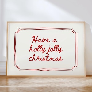 May include: A white framed print with a red handwritten message that says "Have a holly jolly christmas" inside a red decorative frame.