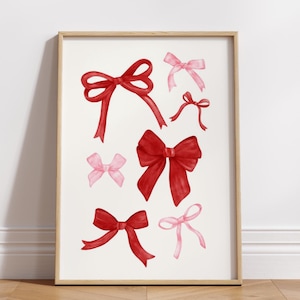 May include: A printable art print featuring a collection of red and pink watercolor bows. The bows are arranged in a random pattern on a white background.