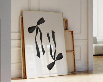 May include: A framed black and white print of two black ribbon bows on a white background.
