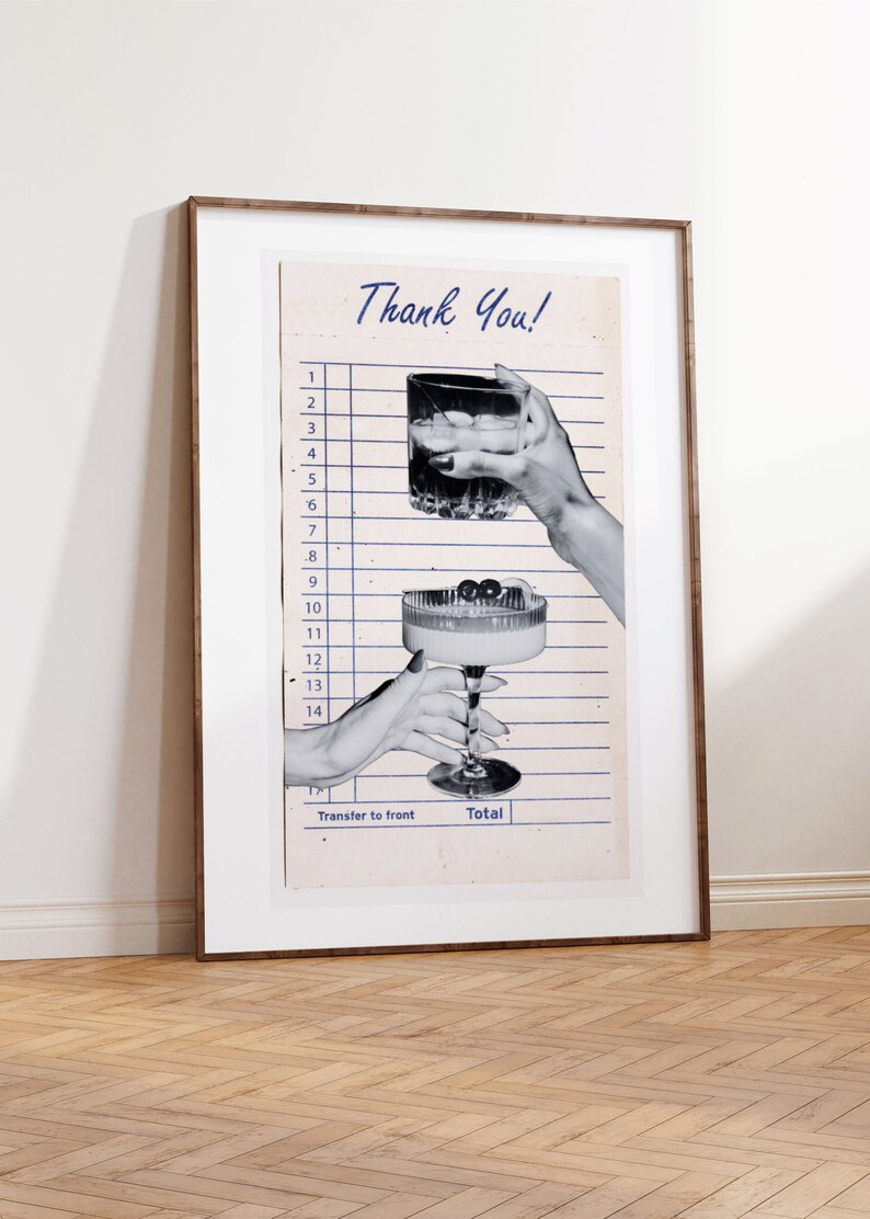 May include: A framed print featuring a vintage-style receipt with the words "Thank You!" at the top. The image shows two hands holding cocktails, one a rocks glass and the other a coupe glass. The print is in a wooden frame.