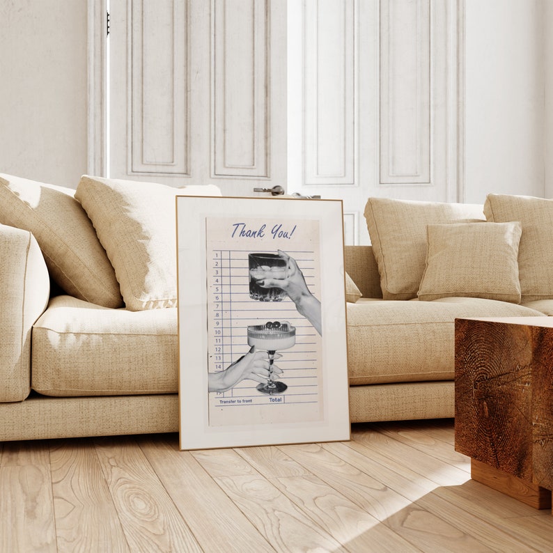 May include: A framed print featuring a vintage-style receipt with the words "Thank You!" at the top. The image shows two hands holding cocktails, one with ice and the other with cherries. The frame is gold.