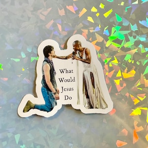 May include: A sticker featuring two figures with the text "What Would Jesus Do." One figure is kneeling, and the other is standing with a microphone. The background is a holographic, iridescent pattern.