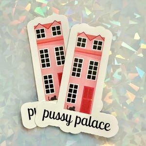 May include: Two stickers featuring pink house illustrations with black windows and doors, and a black cat silhouette. The stickers have the text "pussy palace" in a cursive font.
