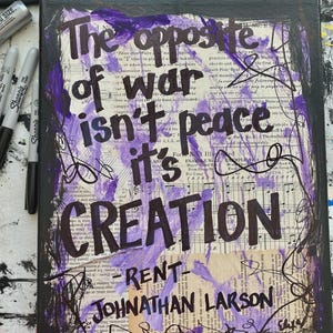 May include: A canvas art piece with the quote "The opposite of war isn't peace, it's creation" in black lettering. The background features sheet music and purple paint strokes, with the name "Jonathan Larson" at the bottom.