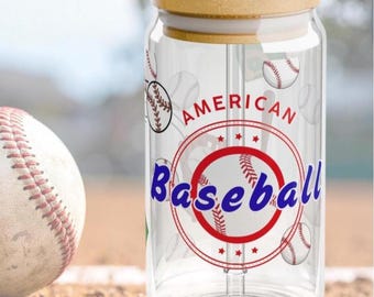 May include: A clear glass tumbler with a bamboo lid and a clear straw. The glass features a baseball-themed design with red and blue text reading American Baseball, surrounded by illustrations of baseballs and red circular accents.
