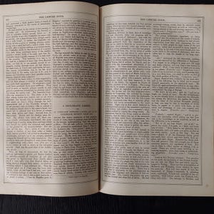 May include: Open book pages with text and illustrations. The left page features text under the title "THE LEISURE HOUR" and the right page has text under the same title. The text is in black font.