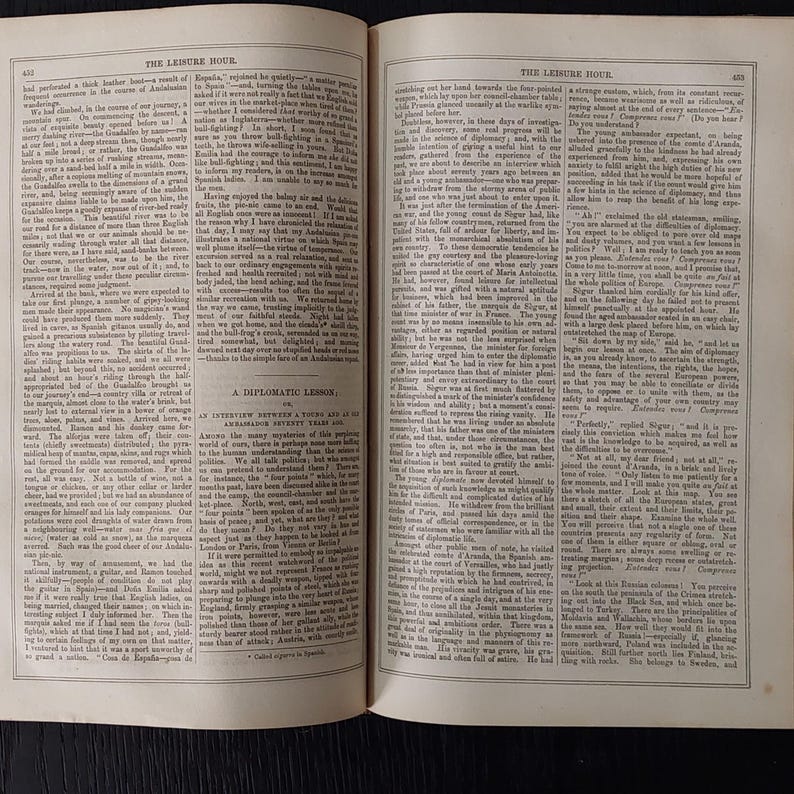 May include: Open book pages with text and illustrations. The left page features text under the title "THE LEISURE HOUR" and the right page has text under the same title. The text is in black font.