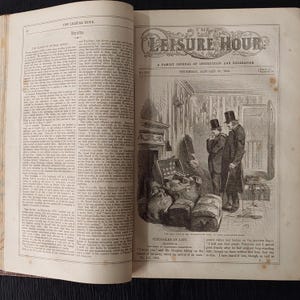 May include: An open book with text and illustrations. The title "The Leisure Hour" is visible at the top, with an illustration of two men in a room with luggage. The date "Thursday, January 25, 1855" is also visible.