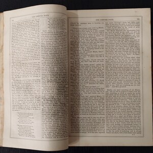 May include: Open book with text on aged paper. The pages are yellowed, and the text is in a classic serif font. The book is open to a double-page spread, with text filling both sides. The title "THE LEISURE HOUR" is visible at the top of each page.