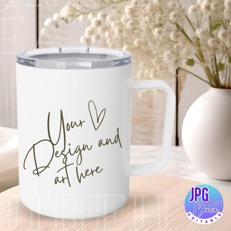Op de afbeelding: Witte reistumbler van roestvrij staal met een zwarte deksel en handvat. Op de tumbler staat de tekst "Your Design and art here" in een cursief schrift.