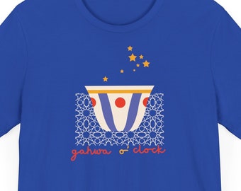 May include: A royal blue t-shirt with a white, blue, and red illustration of a traditional coffee pot with stars above it. The text "gahwa o'clock" is printed below the pot.
