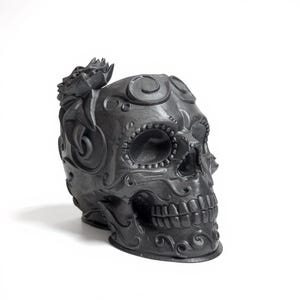 May include: A dark grey decorative skull with detailed floral and swirl patterns. The skull has detailed eye sockets, teeth, and a floral embellishment on top. This Day of the Dead-themed skull is a unique home decor item.
