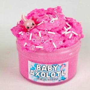 May include: Pink slime with white sprinkles and a pink axolotl charm in a clear jar with a label that reads "Baby Axolotl Slime Dazzle".