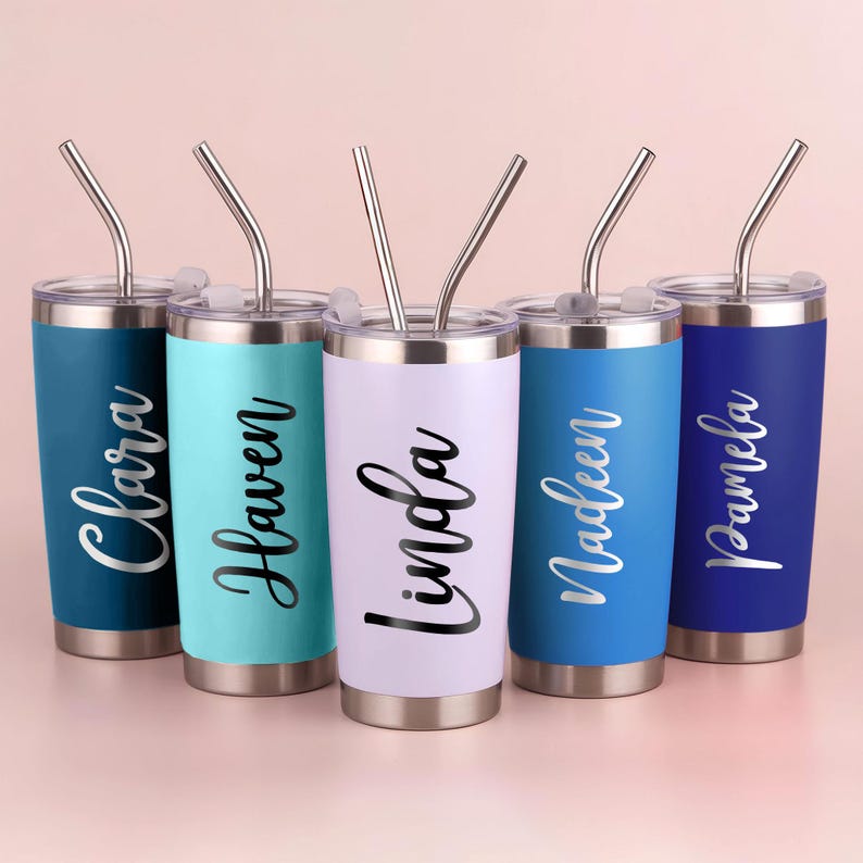 May include: Five personalized tumblers in shades of blue, teal, and lavender, each with a silver straw. The names "Clara", "Haven", "Linda", "Nadeen", and "Pamela" are printed in a cursive font on each tumbler.