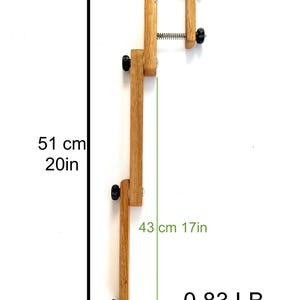 A light brown wooden Mahlstick stand, 51cm (20in) tall and 43cm (17in) wide, weighing 0.83 lbs.  The stand features two adjustable Mahlstick and is constructed from light-colored wood with black metal accents.  It's a versatile woodworking tool, ideal for various crafting and hobby projects.