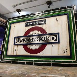 May include: A rustic wooden sign with the text "Welcome to our home" in white lettering. The sign has a distressed finish and a simple, inviting design, ideal for front door decor.