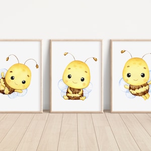May include: Three watercolor illustrations of a cute cartoon bee with yellow and brown stripes and blue wings. The bee is smiling and has big eyes. The bee is in different poses on a white background.